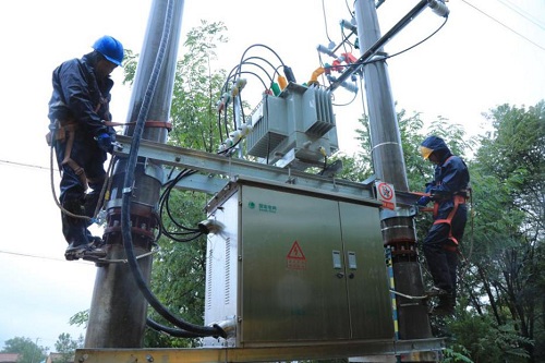 国网甘肃灵台县供电公司员工冒雨抢修台区供电设施。